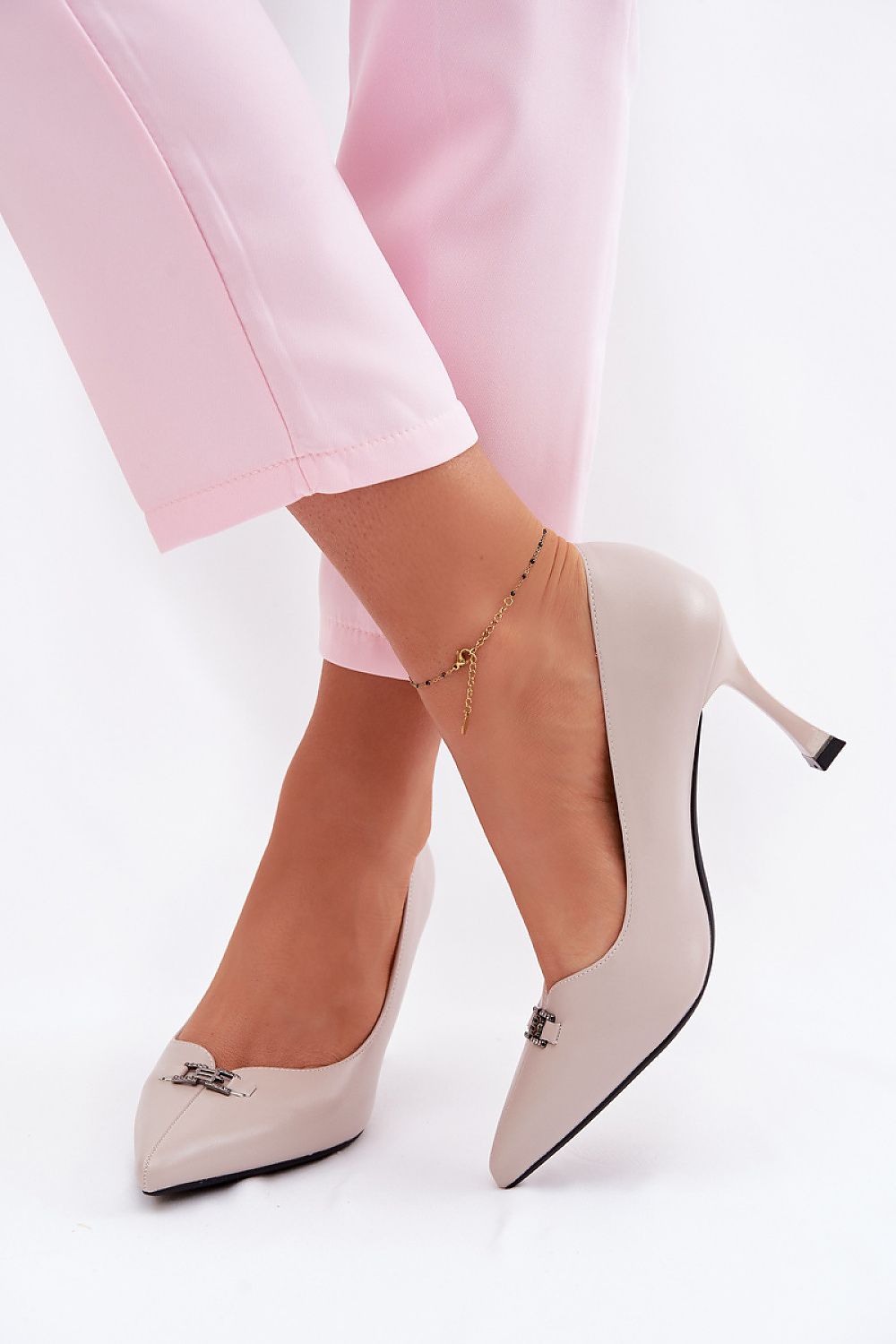 Grey pointed toe heels Valeria Pumps worn with pink trousers, showcasing elegant design and refined silhouette.