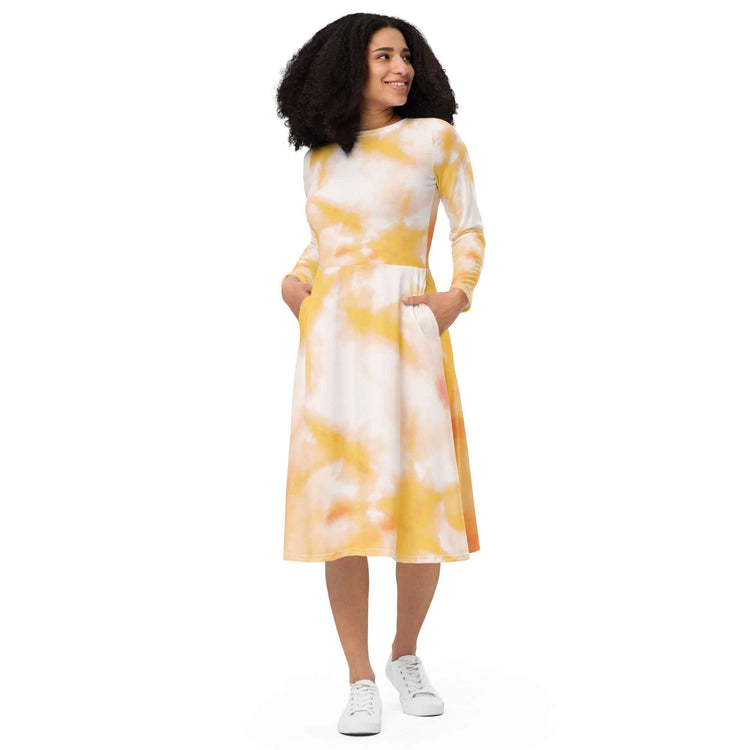 Charming long-sleeve tie-dye midi dress in yellow and white, featuring pockets and a flared hem for a stylish look.